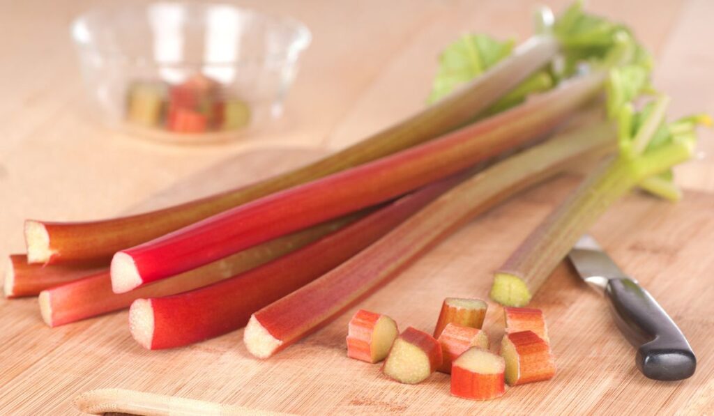 Horizontal of Rhubarb Stalks and Pieces on Wood Counter