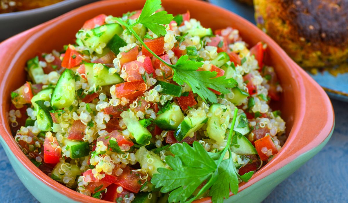 Vegan quinoa salad served in earthen bowl