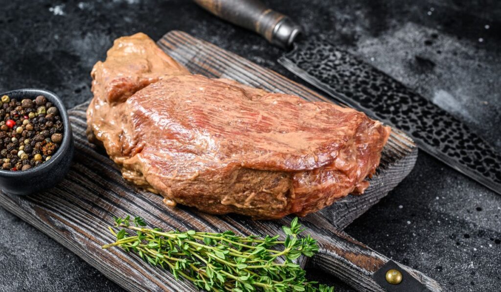 Raw marinated in mustard beef tri-tip steak for bbq