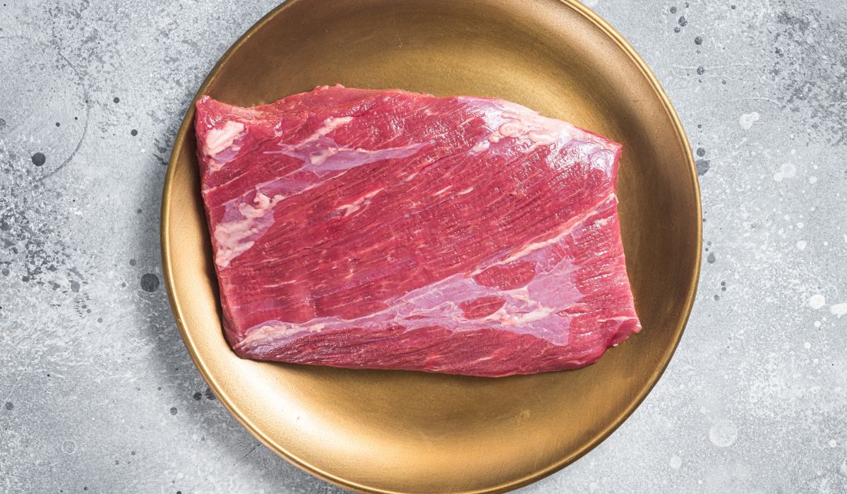 Raw flank beef marbled meat steak on butcher table
